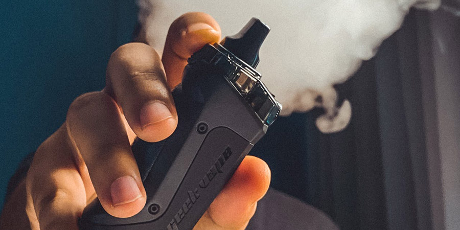 hand holding a black vape device