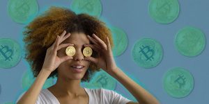 a black girl with afro hair style holding two bitcoins in front of her eyes as if it's sunglasses